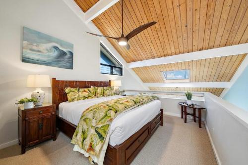 a bedroom with a bed and a wooden ceiling at Kahana Village 32 · KHV 32 Direct Oceanfront Views Remodeled 2BD in Kahana