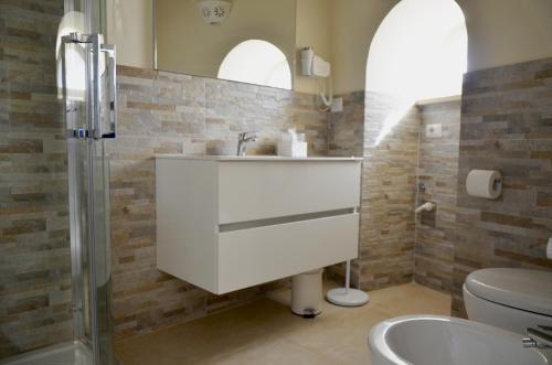 a bathroom with a sink and a toilet at Antica Dimora storica La finestra sul campanile in Matera