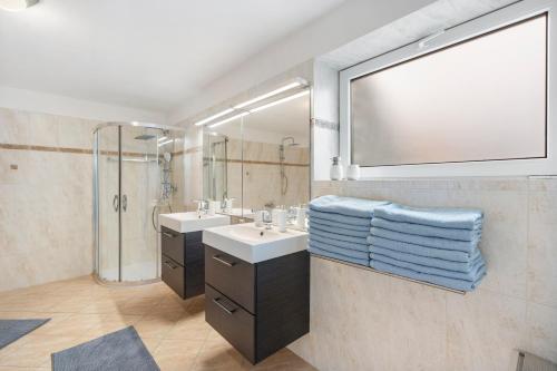 a bathroom with a sink and a shower and a mirror at Black Dragon Haven Luxury Villa with Pool, Sauna & Jacuzzi in Prague