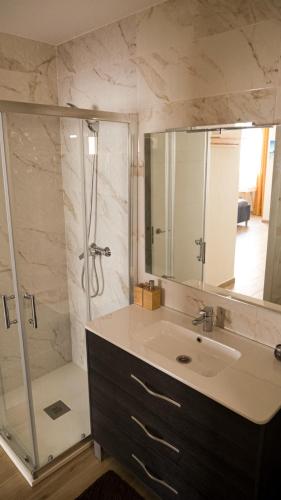 a bathroom with a sink and a shower with a mirror at Zapillo beach in Almería