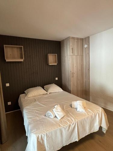 a bedroom with a large bed with two towels on it at VVF Aveyron Najac in Najac