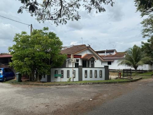 a house on the side of a street at Wareesha Homestay, Corner Lot With Netflix in Padang Serai