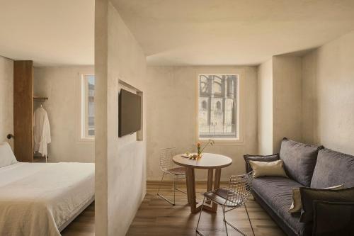 a room with a bed and a couch and a table at Enea Living in Bilbao