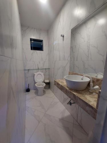 a bathroom with a sink and a toilet at Casa de Arembepe in Camaçari