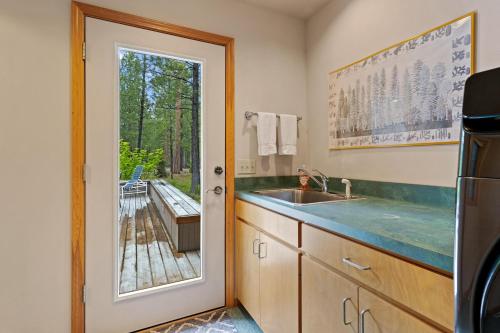 a kitchen with a sink and a view of a deck at Glaze Meadow 376 in Black Butte Ranch
