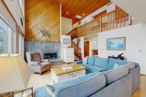 a living room with a blue couch and a fireplace at Cliffside Serenity in Oceanside