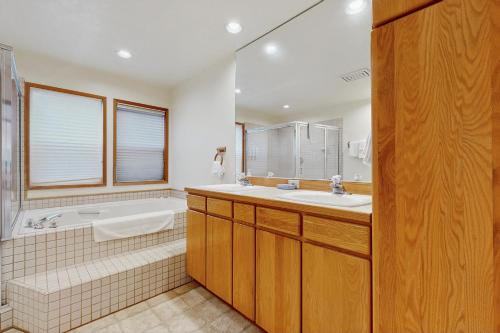 a bathroom with a tub and a sink and a bath tub at Cliffside Serenity in Oceanside