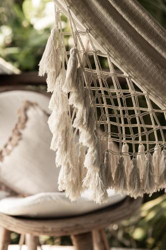 a white bird cage hanging from a table at Casa Chula Hotel Boutique Frente al Mar in Tierra Blanca