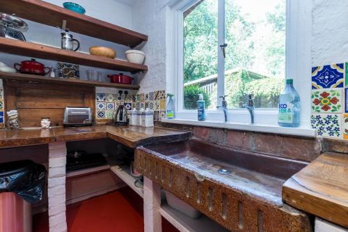 a kitchen with a sink and a window at Large family home based at Westerlands Farm in Graffham