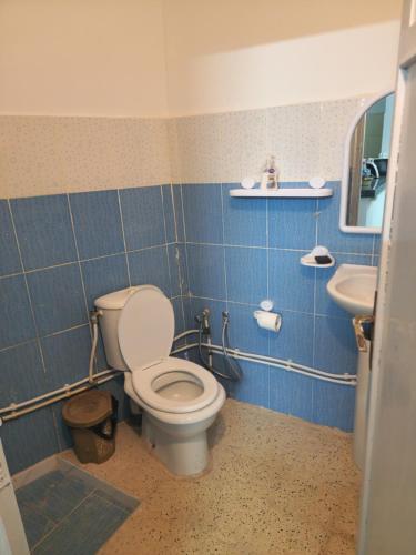 a bathroom with a toilet and a sink at Mechi House in Djerba