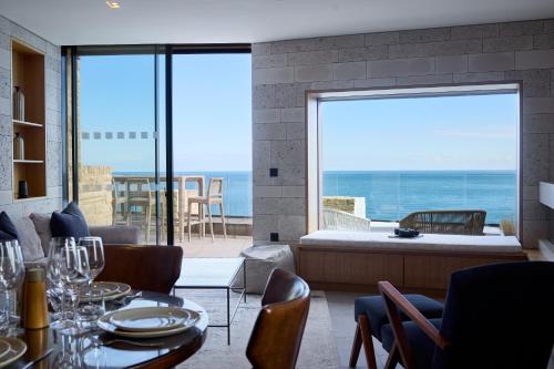 a living room with a view of the ocean at Clifftops - Blue Lodge in Portland