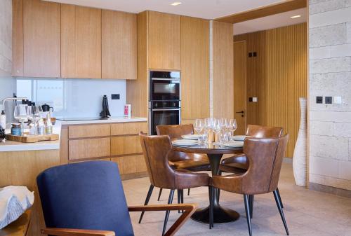a kitchen with a table with wine glasses on it at Clifftops - Blue Lodge in Portland