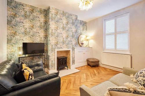 a living room with a couch and a fireplace at Host & Stay - Railway Cottages in Liverpool