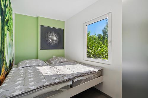 a bed in a room with a window at Ferienhaus 36 in Stelzendorf
