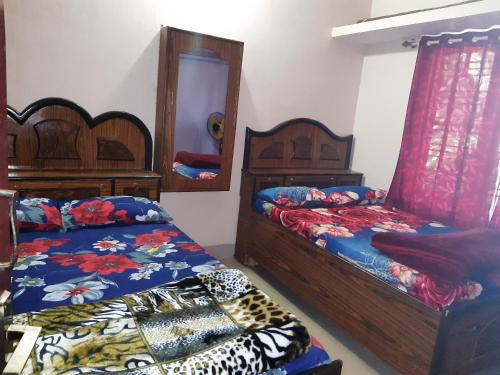 a bedroom with two beds and a mirror at Wood stone step in Napoklu