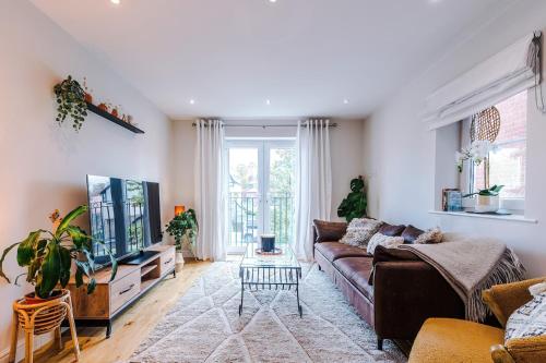 a living room with a couch and a tv at 2 bed, 2 bath apartment in Roundhay in Moortown