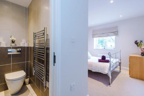 a small bedroom with a bed and a window at 2 bed, 2 bath apartment in Roundhay in Moortown