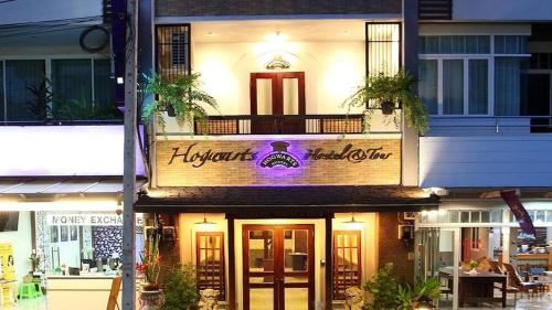 a building with a sign on the front of it at Hogwortz Hostel & Tour in Krabi