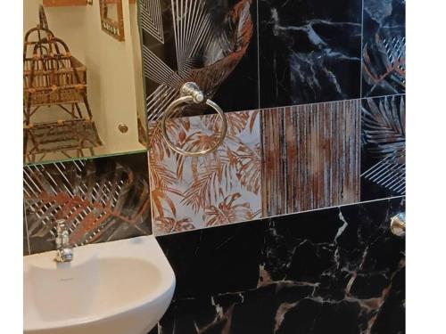 a bathroom with a sink and a mirror at La Goodwill Garden Luxury villa in Auroville