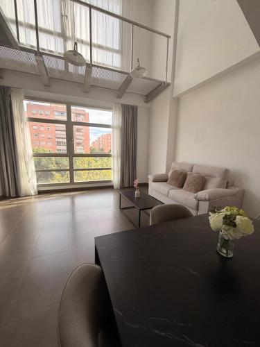 a living room with a table and a couch at Palm Suites Gran Vía in Alicante