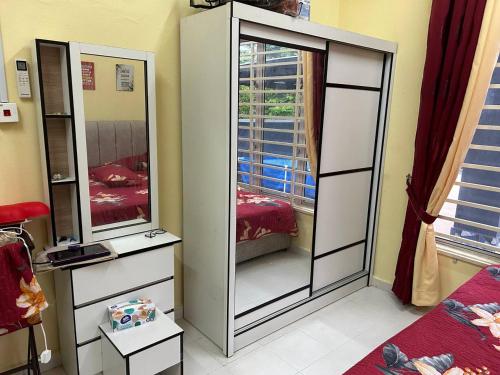 a bedroom with two large mirrors and a bed at Wan Z Homestay Pasir Mas in Pasir Mas