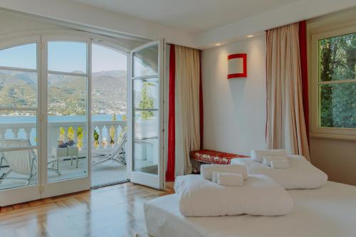 a hotel room with two beds and a balcony at Villa Aria in San Felice del Benaco