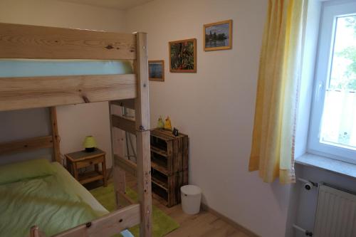 a bedroom with two bunk beds and a window at Haus Kathan in Bechtersweiler