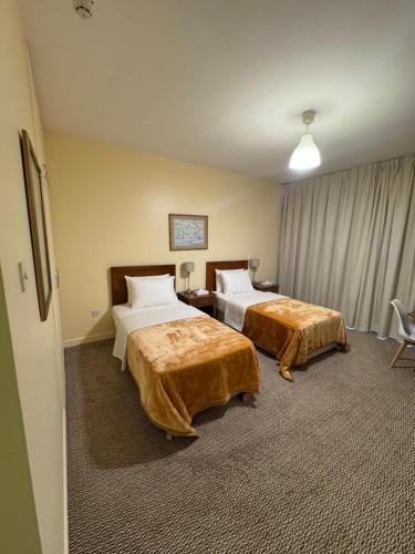 a hotel room with two beds in a room at Top Hotel Apartments in Al Ain