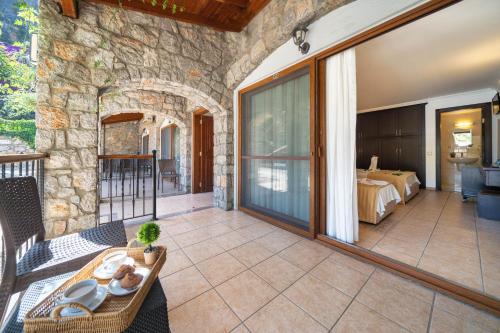 an outdoor patio with a room with a bed at Ata Lagoon Beach Hotel in Oludeniz