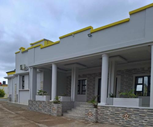 a rendering of a house with columns at Silk Mbare Guest House in Manzini