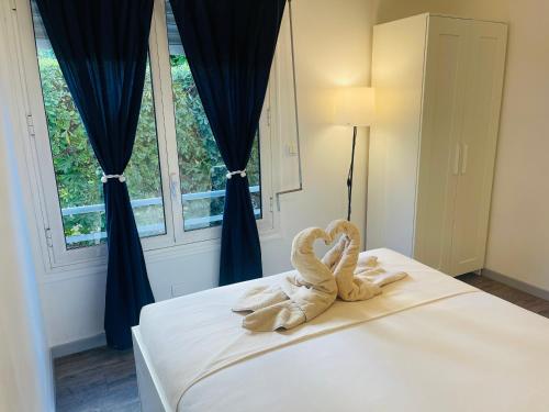 a towel animal sitting on a bed in a bedroom at centre Golf Juan - beach & train station in Vallauris