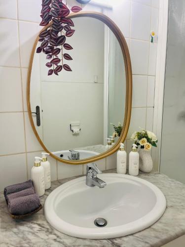 a bathroom sink with a round mirror and a sink at centre Golf Juan - beach & train station in Vallauris