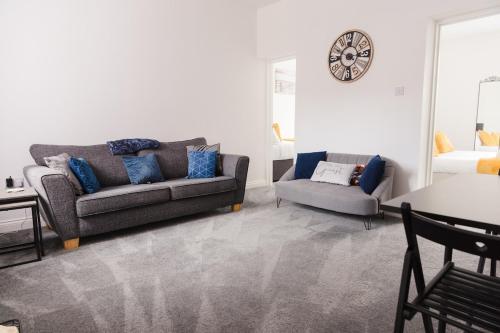 a living room with a couch and a table at Northumberland Cosy Home in Bedlington