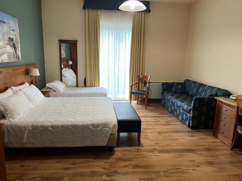 Postel nebo postele na pokoji v ubytování Hotel De La Ville