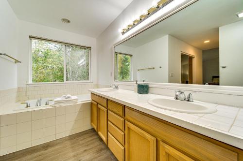 a bathroom with two sinks and a large mirror at 6 Mi to Microsoft HQ! Remote Work Retreat in Redmond