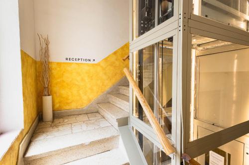 a staircase in a house with a glass door at Hostal Vidamia in Málaga
