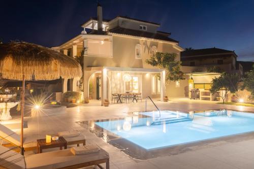 a large swimming pool in front of a house at Porta Verde Luxury Residence, By TK Premium Stays in Laganas