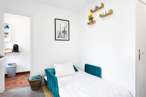 a bedroom with a bed with a blue couch at Le Parisii I Proche RER C & METRO 7 I 2-3 peoples in Ivry-sur-Seine