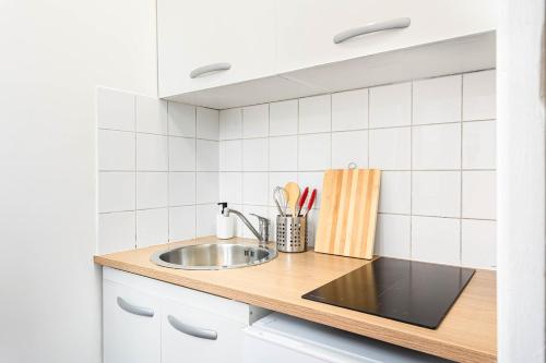 a kitchen with a sink and a counter at Le Parisii I Proche RER C & METRO 7 I 2-3 peoples in Ivry-sur-Seine