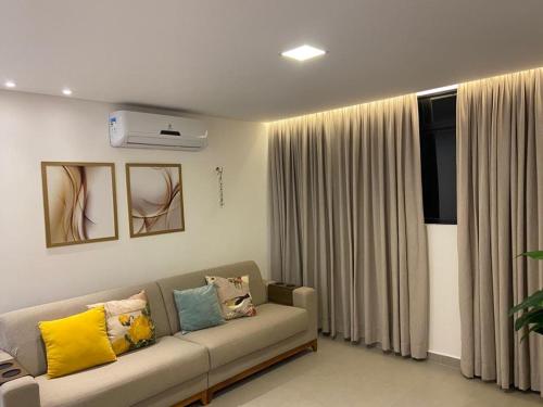 a living room with a couch and a window at Thainá · Apartamento amplo proximo a praia do Bessa. in Nossa Senhora do Livramento