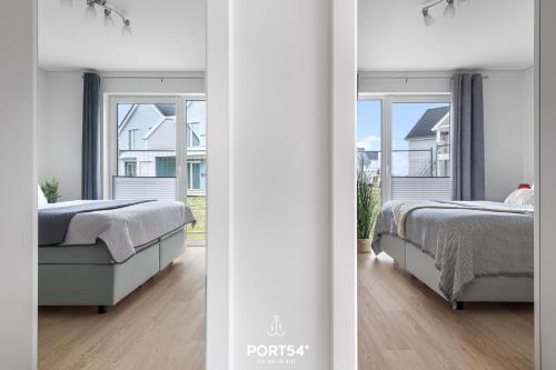 OlpenitzdorfにあるFerienwohnung Balance Hus Olpenitzのベッド2台と窓のある寝室