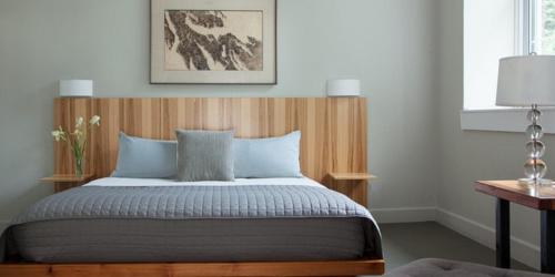 a bedroom with a bed with a wooden headboard at Ledges Hotel in Hawley