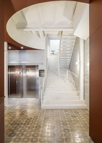 a staircase in a building with a white stair case at BYPILLOW Flamant in Barcelona