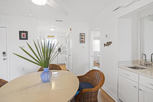 a kitchen with a table with a vase on it at 33C Lighthouse Point in Tybee Island