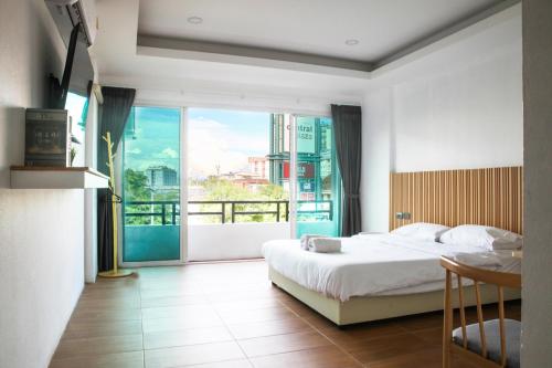 a bedroom with a bed and a large window at THE BEST ONE CHIANG MAI in Chiang Mai