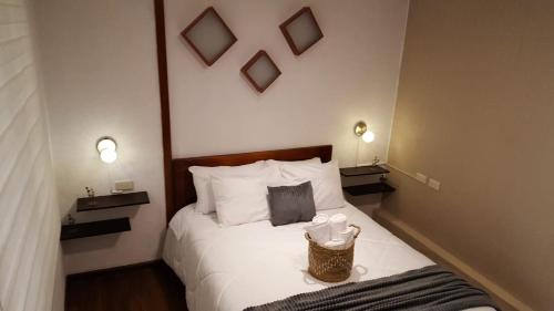 een hotelkamer met een bed met twee kopjes erop bij Suite Numa in Cuenca