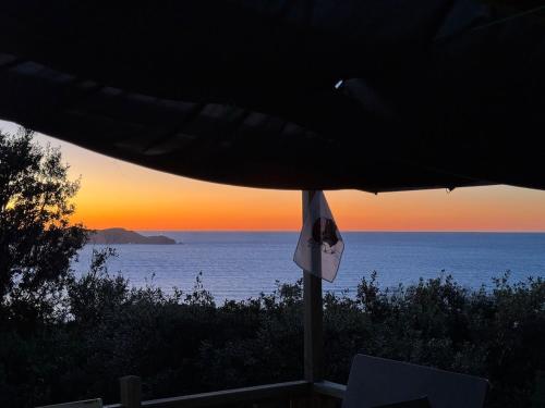 a view of the ocean at sunset from a patio at Notre paradis in Lumio