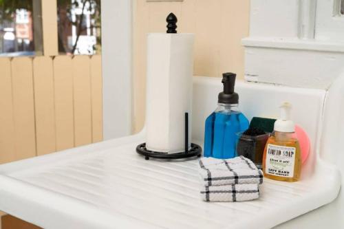 a bathroom counter with a sink with toiletries on it at Historic Birmingham 4 BR 3 Bath in Birmingham