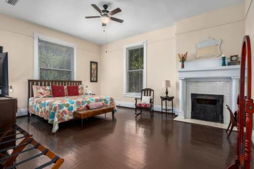 a living room with a bed and a fireplace at Historic Birmingham 4 BR 3 Bath in Birmingham