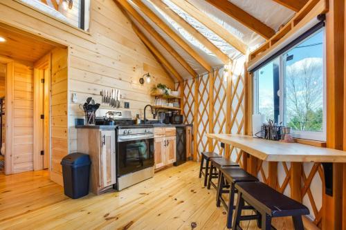 a kitchen with a table and chairs in a cabin at Sunrise Sanctuary -Modern Yurt in Brookville